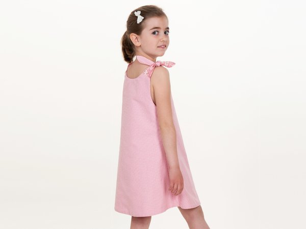 Multi-seasonal girls dress sewing pattern with bow, pocket, reversible